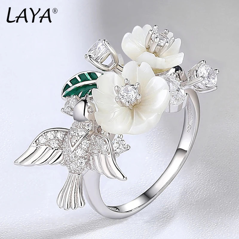 Flaunt your fun, whimsical side with this Zircon and Natural Shell Bird and Flowers Women's Ring. Available in Sterling Silver or Rose Gold, the ring features a unique bird and flower design crafted with sparkling zircon and natural shell. A playful addition to any outfit!