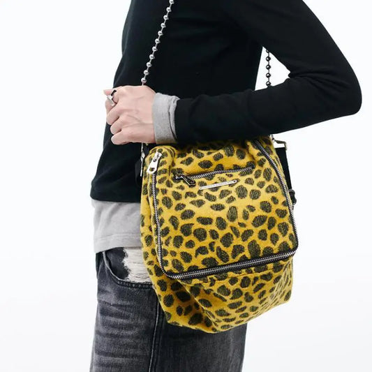 Make a statement with our Fashionable Leopard Print Satchel! This stylish accessory is perfect for those who want to showcase their wild side. The eye-catching leopard print adds a touch of sophistication to any outfit, and the spacious design allows for ample storage. Be bold, be trendy, with our satchel!