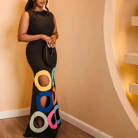 Elevate your style with our black sleeveless maxi dress! Adorned with colorful cut out circles, this dress exudes elegance and playfulness. The flowy silhouette and soft fabric ensure maximum comfort and freedom of movement. Perfect for any occasion, this dress is a must-have for your wardrobe.