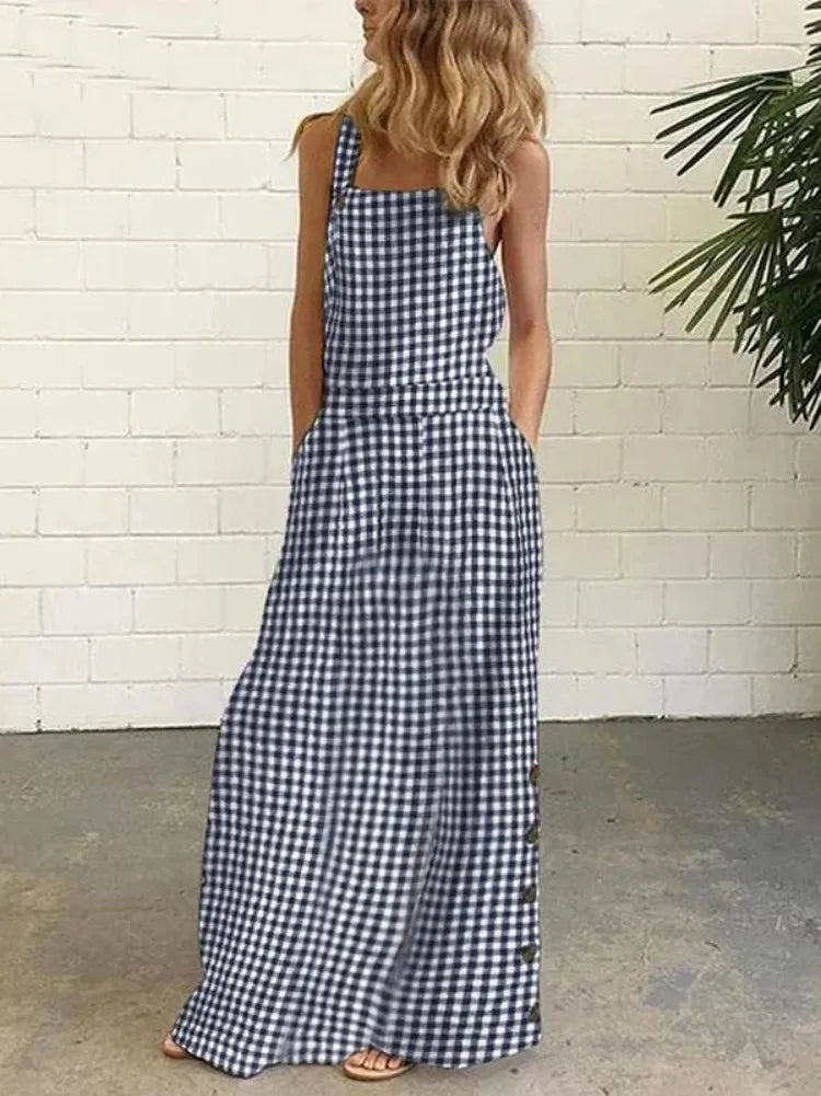 In Navy Blue - Elevate your summer wardrobe with our Bib Overall Style Maxi Dress! Available in vibrant Yellow or Blue Plaid, this statement piece from Thread Harbor Clothing Company combines the classic look of gingham with modern style. Decorative buttons down the sides add a touch of charm to this must-have dress. Feel confident and stylish in this bold and unique piece!