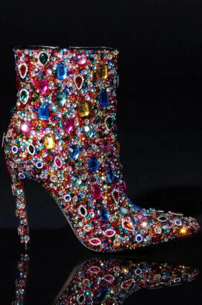 Walk with style in these luxurious Designer Women's Multi Colored Rhinestone Boots. The intricate rhinestone design adds a touch of elegance to any outfit, while the high-quality materials ensure durability and comfort. Elevate your wardrobe with these exclusive boots that are sure to turn heads.