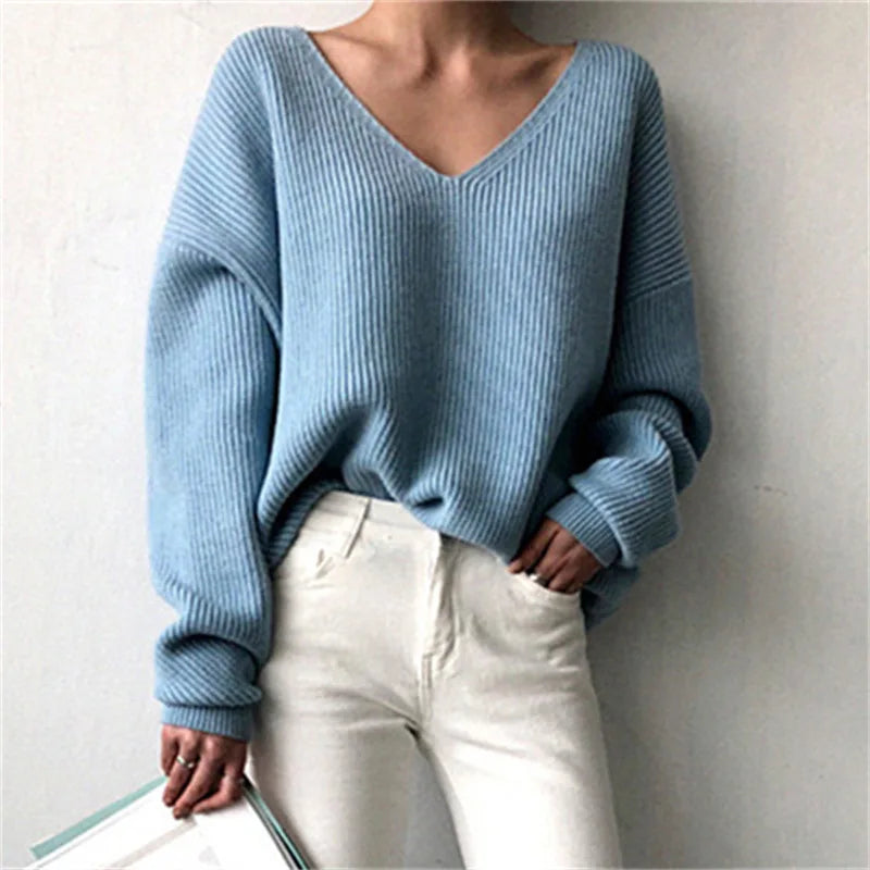 In Blue.  Stay cozy and stylish this fall and winter with our Elegant Solid Color Ribbed V-Neck Sweater. Crafted with an oversized fit and soft knit fabric, this sweater will keep you warm while making a fashion statement. Embrace the season in comfort and elegance.