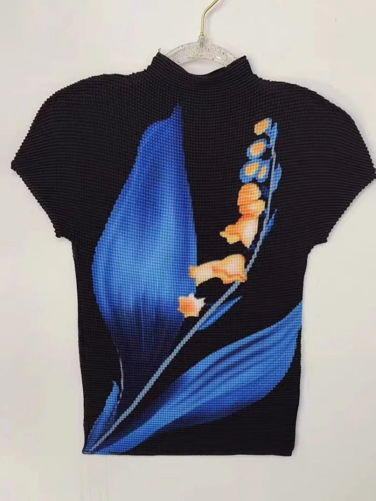 Elevate your wardrobe with our Elegant Black Short Sleeve Tee Shirt! Featuring a stunning high neckline and a large floral print in shades of blue, this top is sure to turn heads. Made with stretch fabric for ultimate comfort, it also boasts two large blue leaf designs with pops of beige and yellow for a chic touch.