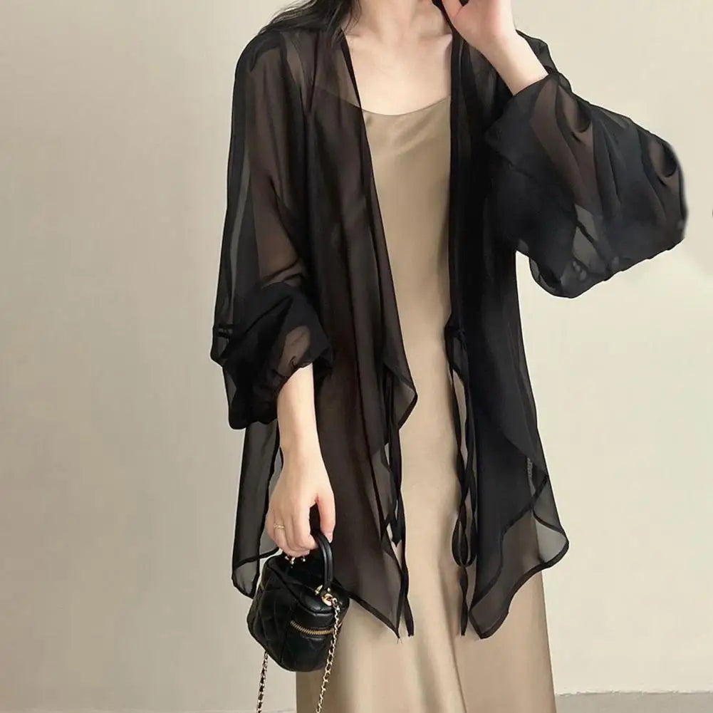 Stay stylish and protected this summer with our Long Sleeve Chiffon Sunscreen Cover Up! Made with lightweight chiffon material, it features a front tie closure for easy adjustability. Available in black, white, and khaki, this cover up is the perfect addition to your summer wardrobe.