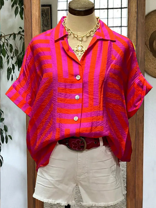 ransform your wardrobe with our Button Down Cotton Blouse! Made from high-quality cotton, this blouse features a trendy turn down collar and short sleeves for a chic look. The vibrant tribal print in bright pink, orange, and purple stripes adds a pop of color to any outfit. With its button down design and unique slit back, this blouse is both stylish and functional. Upgrade your style game today!