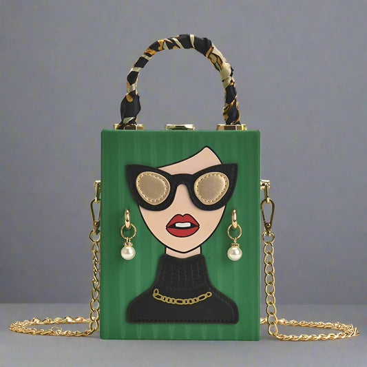 At the heart of this bag's design is the charming appliqué of a lady's face, featuring oversized black glasses and dangling earrings. The playful yet chic design adds a touch of personality and flair to any outfit, making it a standout piece in your collection.