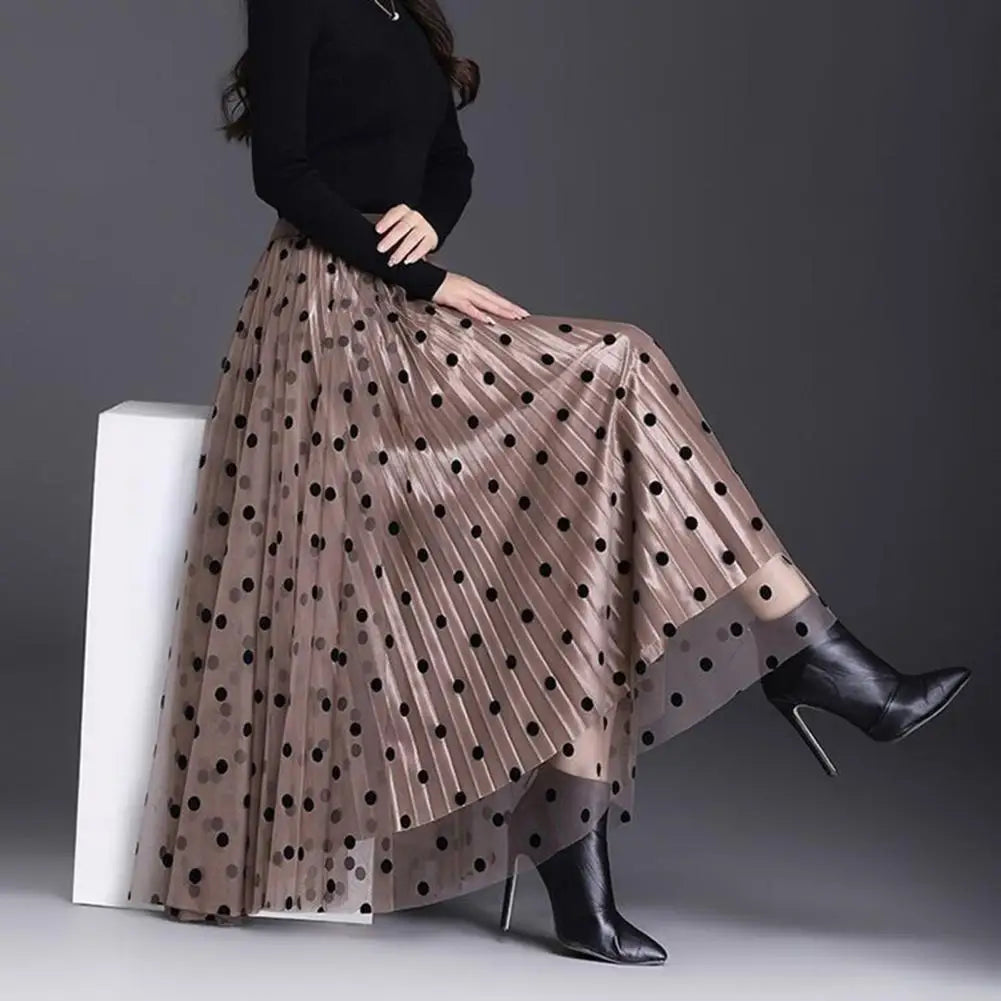 Model sitting with pleated side out and showing very full skirt with mesh underneath.  The skirt is mid length 