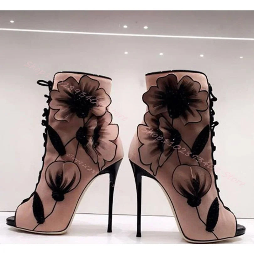 Add a unique touch to your shoe collection with these Flower Lace Up Boots. The dusty pink stiletto heels and open toe design are complemented by black lace flowers adorning the entire boot. With black trim and laces, these boots are perfect for making a statement while still being versatile.