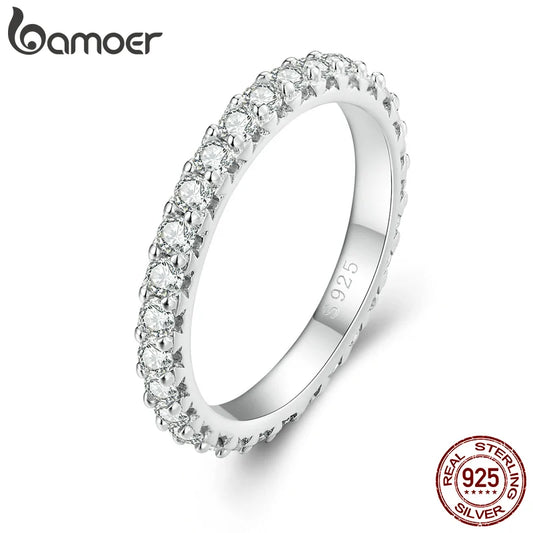 Sparkle and shine with our Sterling Silver Moissanite Stackable Finger Ring! Made with gleaming sterling silver and dazzling moissanite stones, this fine jewelry piece will add a touch of elegance to any outfit. Perfect for stacking, this ring is a versatile and luxurious accessory to add to your collection.