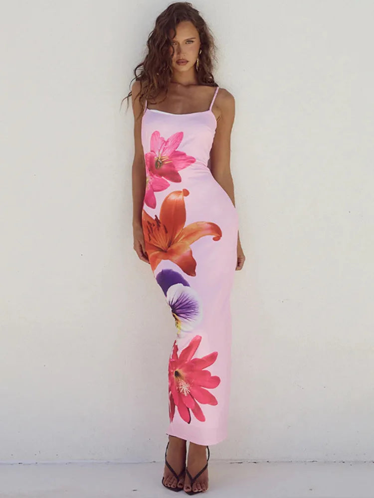 Pink background with large pink, orange and purple day lilies across dress.