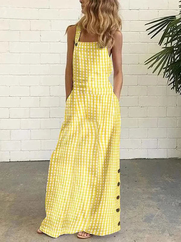 Elevate your summer wardrobe with our Bib Overall Style Maxi Dress! Available in vibrant Yellow or Blue Plaid, this statement piece from Thread Harbor Clothing Company combines the classic look of gingham with modern style. Decorative buttons down the sides add a touch of charm to this must-have dress. Feel confident and stylish in this bold and unique piece!