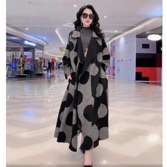 Introducing our Beautiful Graphic Print Trench Coat, featuring a stunning black and gray polka dot pattern. This mid-length coat is not only stylish, but also functional with its plus sizes. Make a bold fashion statement with its geometric design!