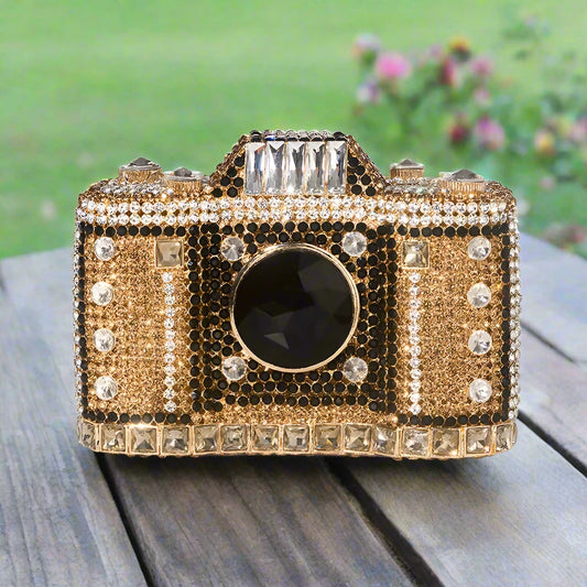 Capture everyone's attention with this Camera Shaped Rhinestone Evening Clutch Bag! The super cute retro design is adorned with sparkling rhinestones, making it an eye-catching accessory for any occasion. With a convenient chain shoulder strap, you can be hands-free while rocking this unique and playful clutch. Say cheese!