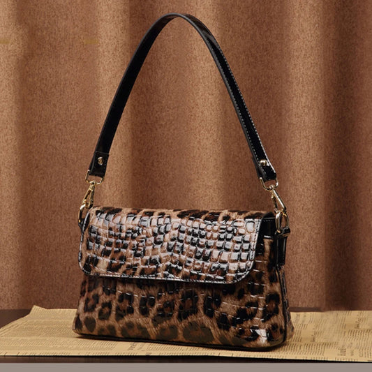 Indulge in sophistication with our Leopard Print Leather Small Shoulder Bag. Crafted from shiny leather, the elegant leopard print adds a touch of exclusivity. Featuring a detachable leather strap, an outside zipper pocket on the back, and a flap front, this bag is both stylish and practical.