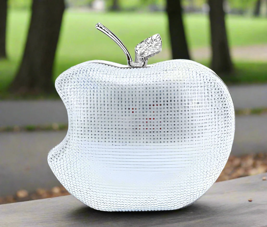 Get ready to shine with our Rhinestone Apple Novelty Clutch with Chain! The stunning rhinestone design adds a touch of glamour and the detachable chain allows for versatility in wearing. Perfect for a fun night out or a special occasion, this clutch is guaranteed to make a statement and turn heads!