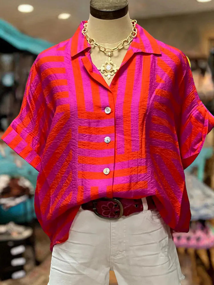 Transform your wardrobe with our Button Down Cotton Blouse! Made from high-quality cotton, this blouse features a trendy turn down collar and short sleeves for a chic look. The vibrant tribal print in bright pink, orange, and purple stripes adds a pop of color to any outfit. With its button down design and unique slit back, this blouse is both stylish and functional. Upgrade your style game today!