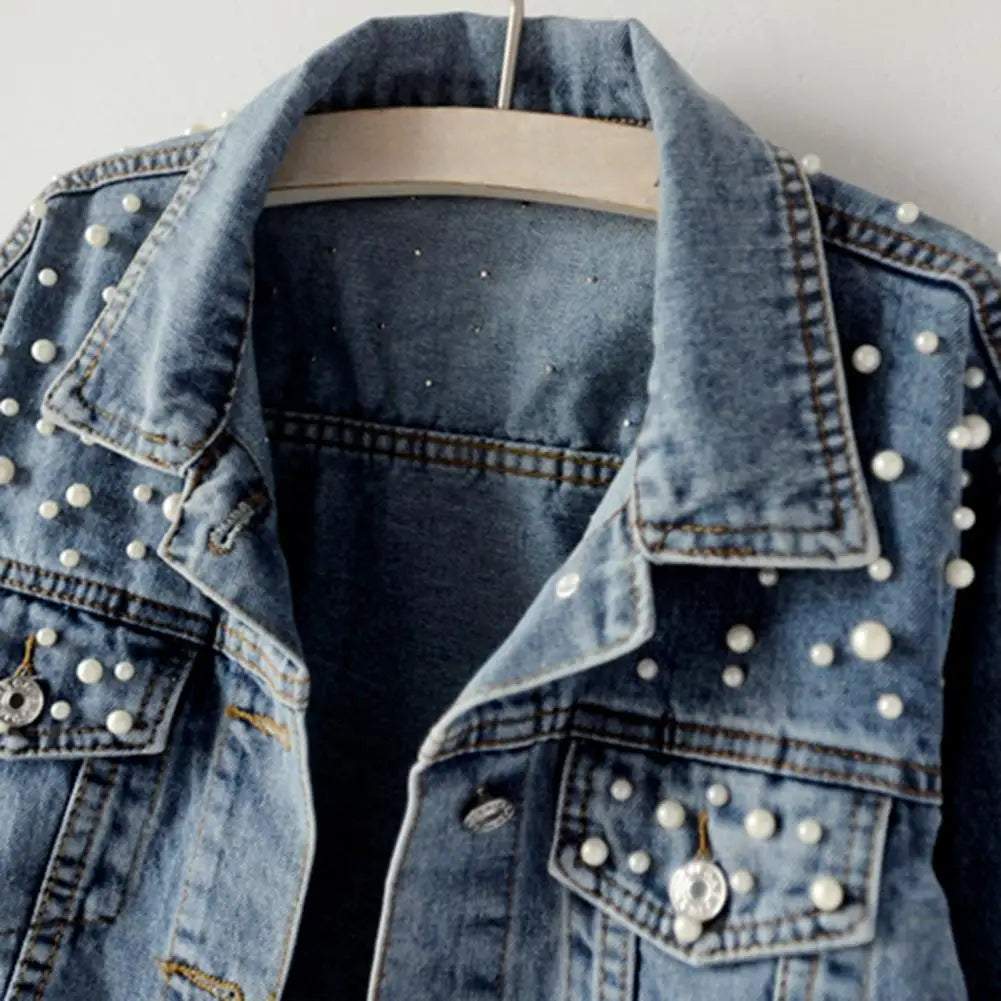 Get ready to rock the denim look with our Denim Jacket! With its solid color and single breasted design, this cropped jacket is perfect for any occasion. Stay warm and stylish with its thermal lining and beaded accents, while adding a touch of elegance with faux pearl details. Upgrade your wardrobe with this must-have piece!