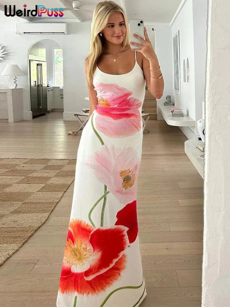 Take your summer style to the next level with our Summer Spaghetti Strap Maxi Length Backless Bodycon Dress. The white background beautifully contrasts with the vibrant pink, red, and orange flowers, making a bold statement. The flattering bodycon fit and backless design will make you stand out in any crowd.