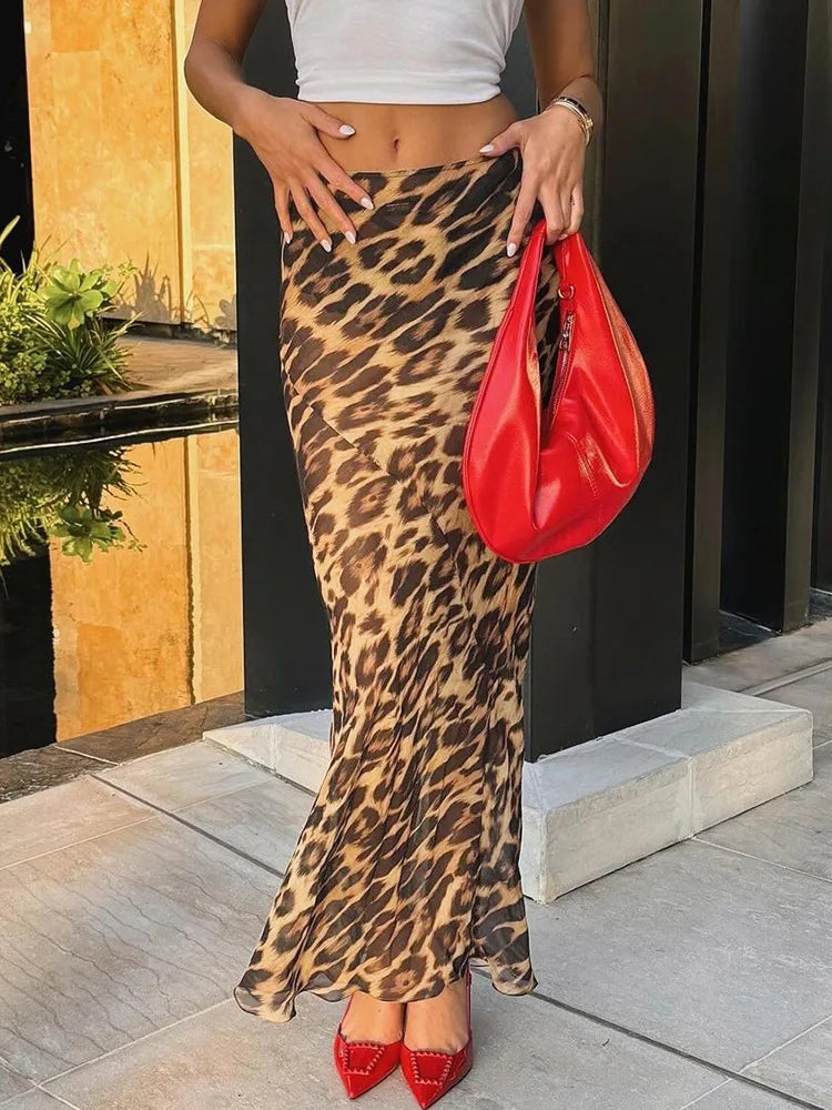 Embrace your wild side with our Leopard Print Chiffon High Waisted Summer Maxi Skirt. Made from light and see through chiffon, this skirt is perfect for a day at the beach. Channel your inner beach goddess and turn heads in this stunning summer essential!