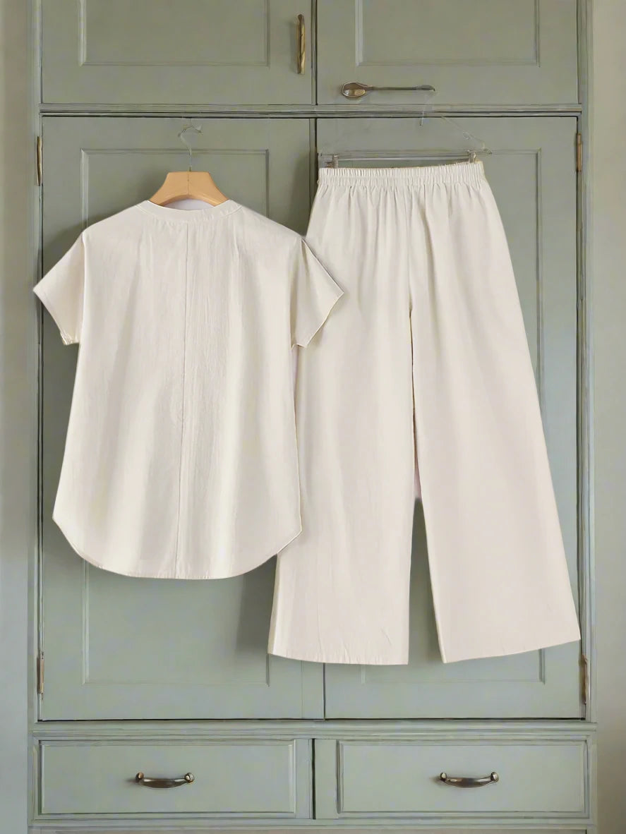 Experience ultimate comfort and style with Thread Harbor Clothing Company's two piece set. Made with soft cotton, this set includes loose-fitting wide leg pants and a matching top with an elastic waist for a relaxed fit. Elevate your everyday look with this essential ensemble!