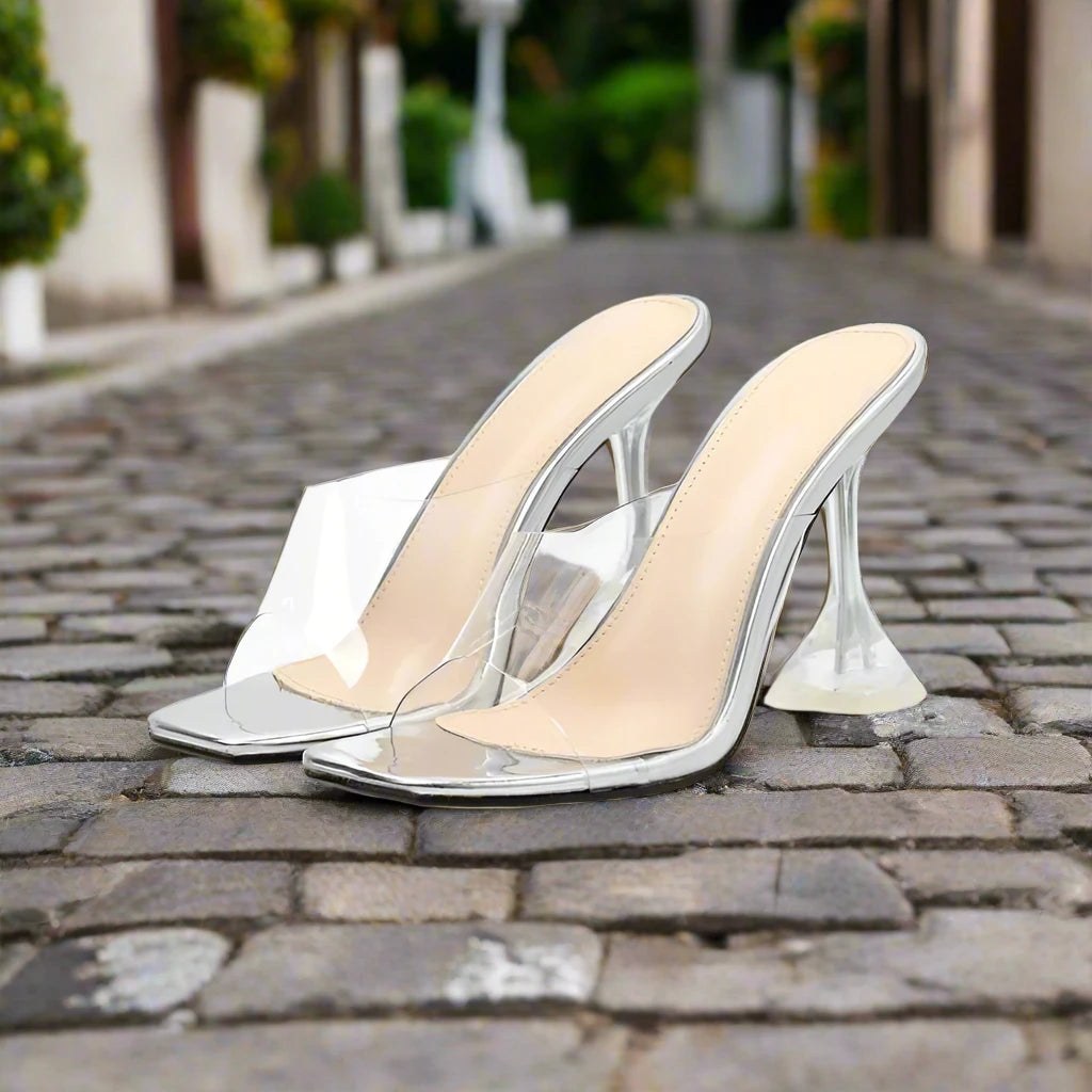 the heels are square at the bottom and clear,  the foot strap is clear.  the foot padding is beige