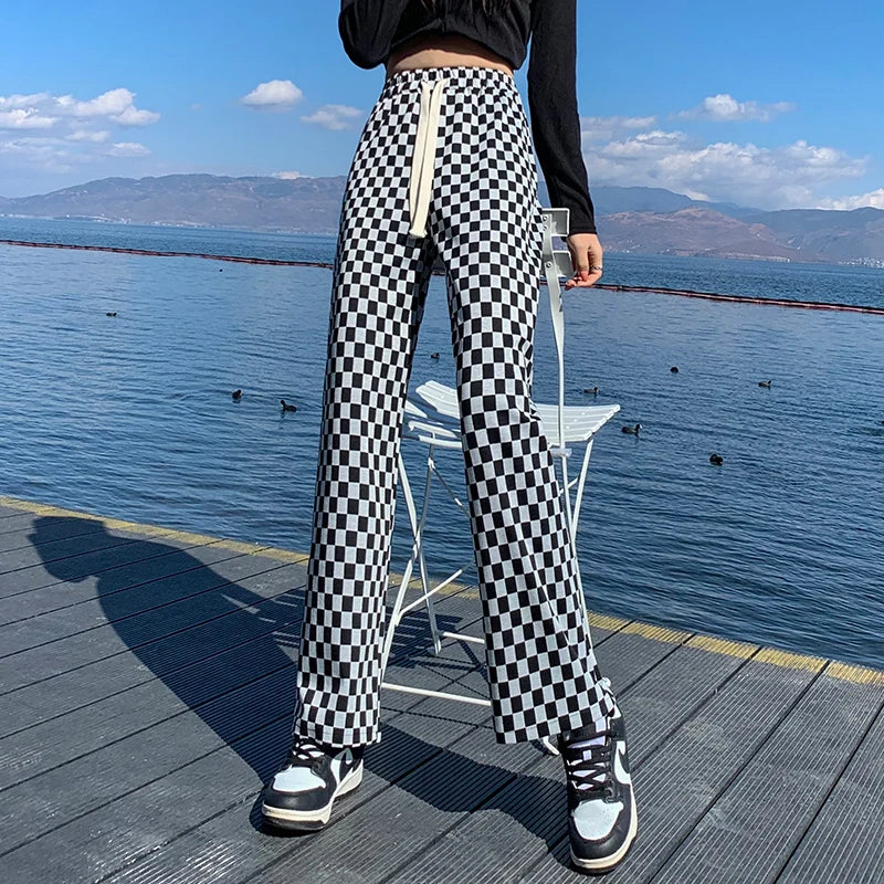 Elevate your casual wardrobe with our Woman's Black and White Checkered Lightweight Casual Pants. These pants offer comfort and style, perfect for any occasion. The black and white checkered design adds a touch of sophistication while the lightweight fabric keeps you cool and comfortable. Elevate your style today!