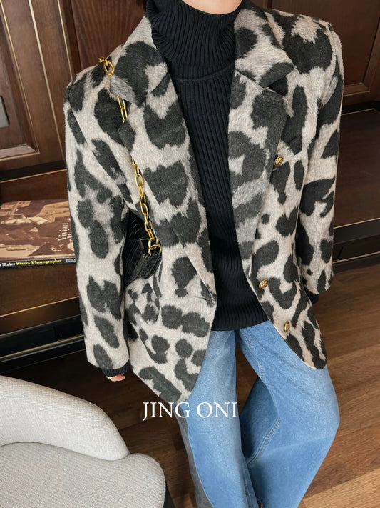 Unleash your wild side with our Wool Blend Leopard Print Blazer. Made with a luxurious wool blend, this blazer is perfect for adding a touch of personality to any outfit. Stand out from the crowd and exude confidence with this stylish and versatile piece.