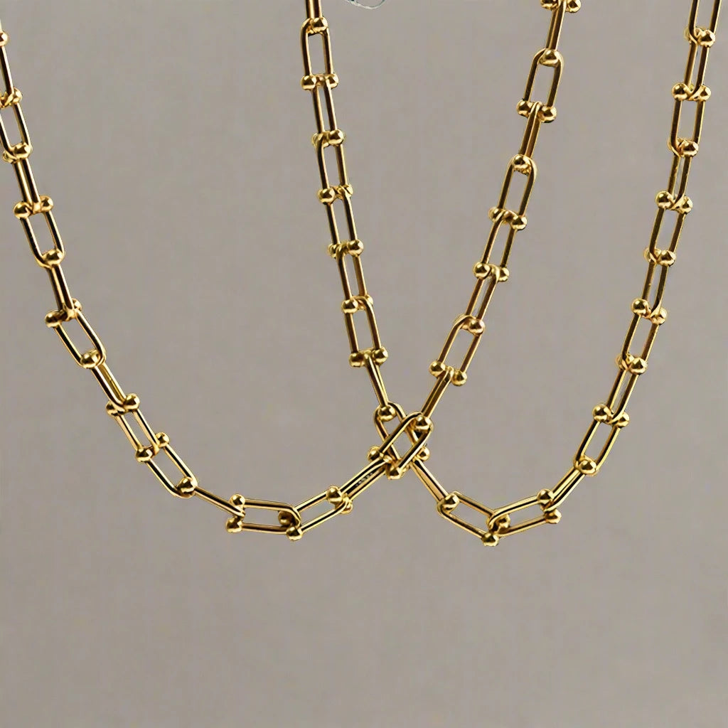 Indulge in the ultimate luxury with our Horseshoe Chain Necklace and Bracelet Set. Made of exquisite 18K gold, this designer jewelry is the perfect accessory for any occasion. Its trendy horseshoe chain design exudes elegance and sophistication, making it a beautiful gift or to elevate any outfit.