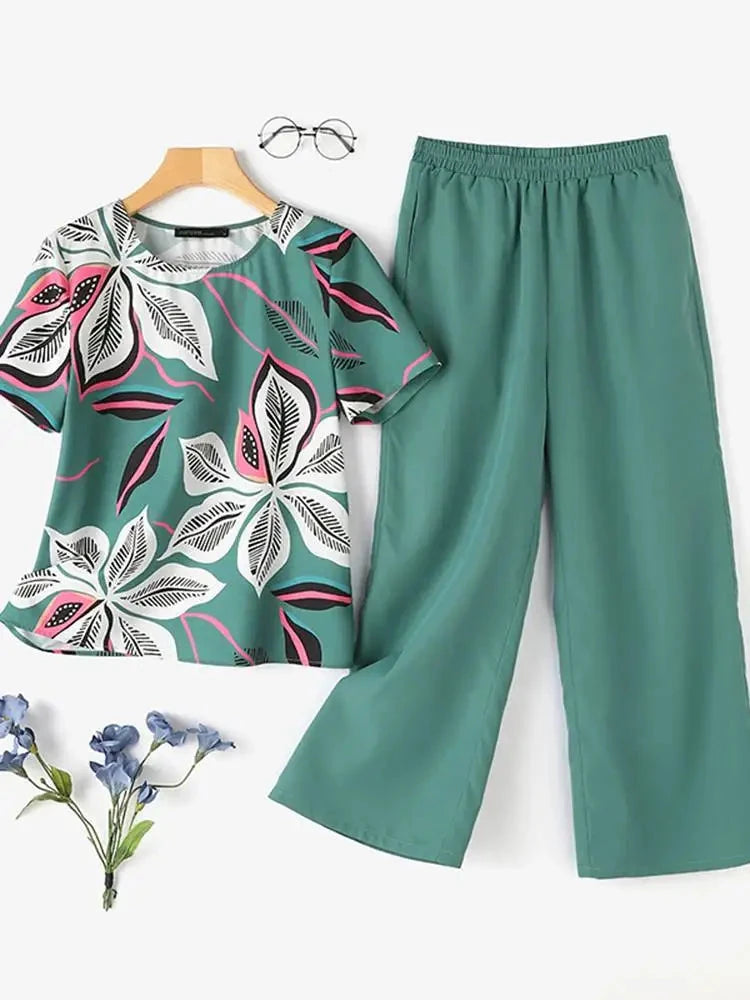 This stunning Floral Short Sleeve Top and Matching Slacks set from Thread Harbor Clothing Company offers both style and functionality. With side pockets in the pants for easy storage, you can stay comfortable and chic all day. Choose from 4 elegant colors and prints to suit your personal style!&nbsp; Small to 5XL