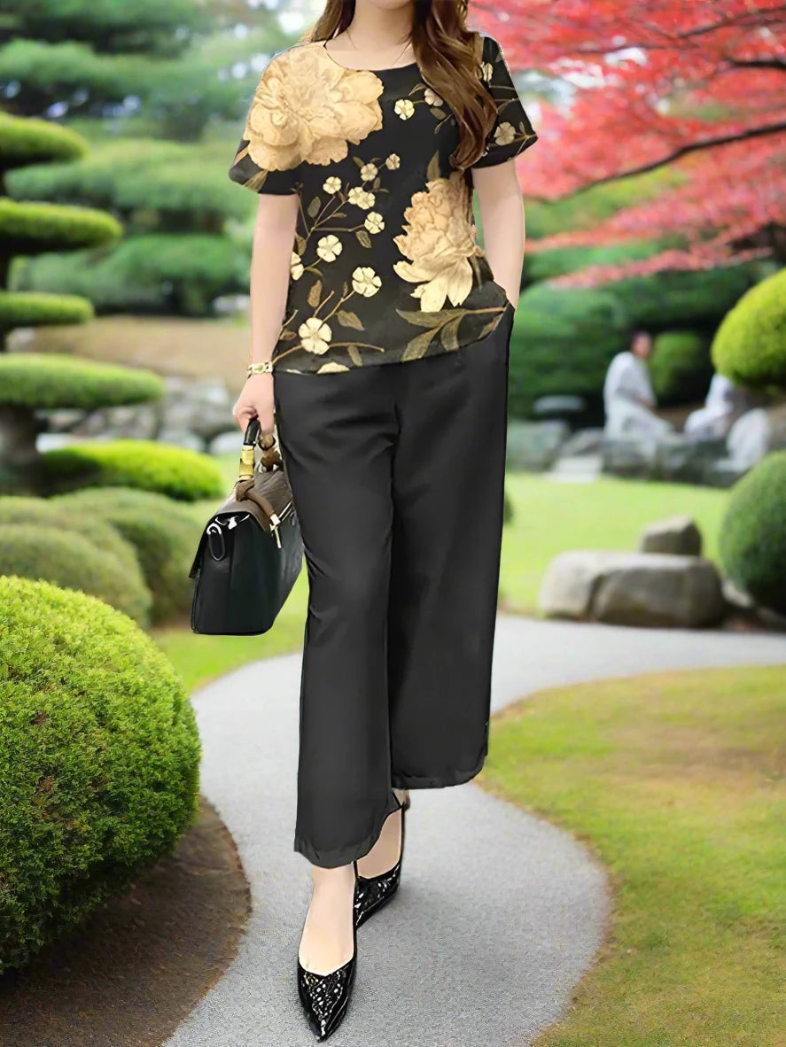 Solid black slacks with a beautiful gold floral design top.  