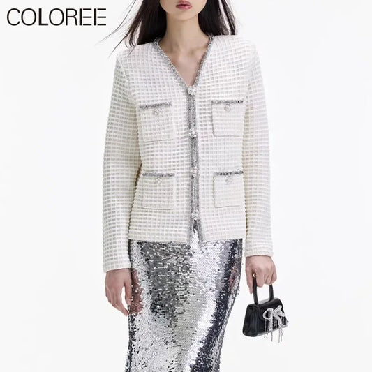 Dazzle in our Luxury White Jacket with Diamond Rhinestone Beading! This elegant V-neck piece is perfect for adding a touch of sophistication to any outfit. The intricate beading and sparkling rhinestones will make you feel like a true fashion icon. Elevate your wardrobe with this stunning jacket today!