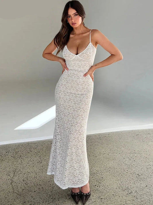 Embrace your feminine side with our V Neck Spaghetti Strap Maxi Slim Fit Lace Dress! This elegant and figure-flattering dress features delicate lace and a slim fit design, perfect for any special occasion. Feel confident and beautiful in this must-have addition to your wardrobe.  In White.  