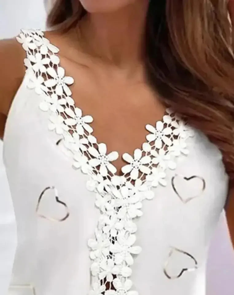 Elevate your summer wardrobe with our White Lace V Neck Tank Top! This beautifully crafted top features delicate heart cut outs, adding a touch of romance to your outfit. The V neck design is perfect for showing off your neckline, making you feel confident and alluring. Don't miss out on this must-have piece!