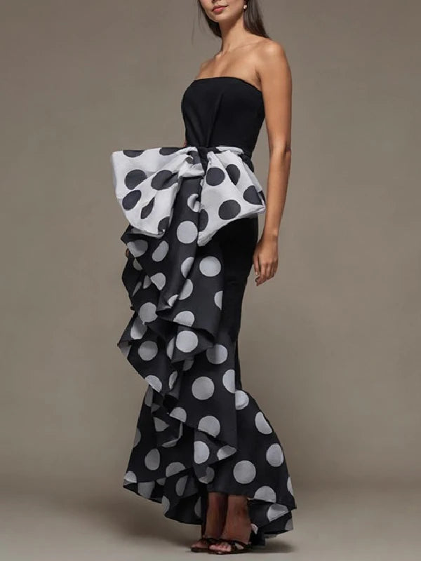 Feel elegant and sophisticated in our stunning black sleeveless evening dress. The polka dot pattern adds a touch of fun, while the bow tie embellishment adds a touch of elegance. Perfect for any special occasion, this dress will make you feel confident and beautiful.