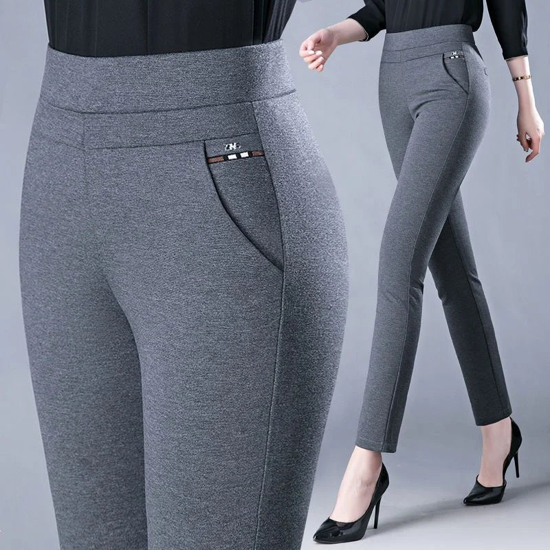 In gray - Elevate your style with our Stretch High Waist Skinny Leg Knit Slacks from Thread Harbor Clothing Company. These pants offer a sleek silhouette and a comfortable fit with their stretchy fabric and high waist design. Perfect for any occasion, they effortlessly flatter your figure while keeping you comfortable all day long.