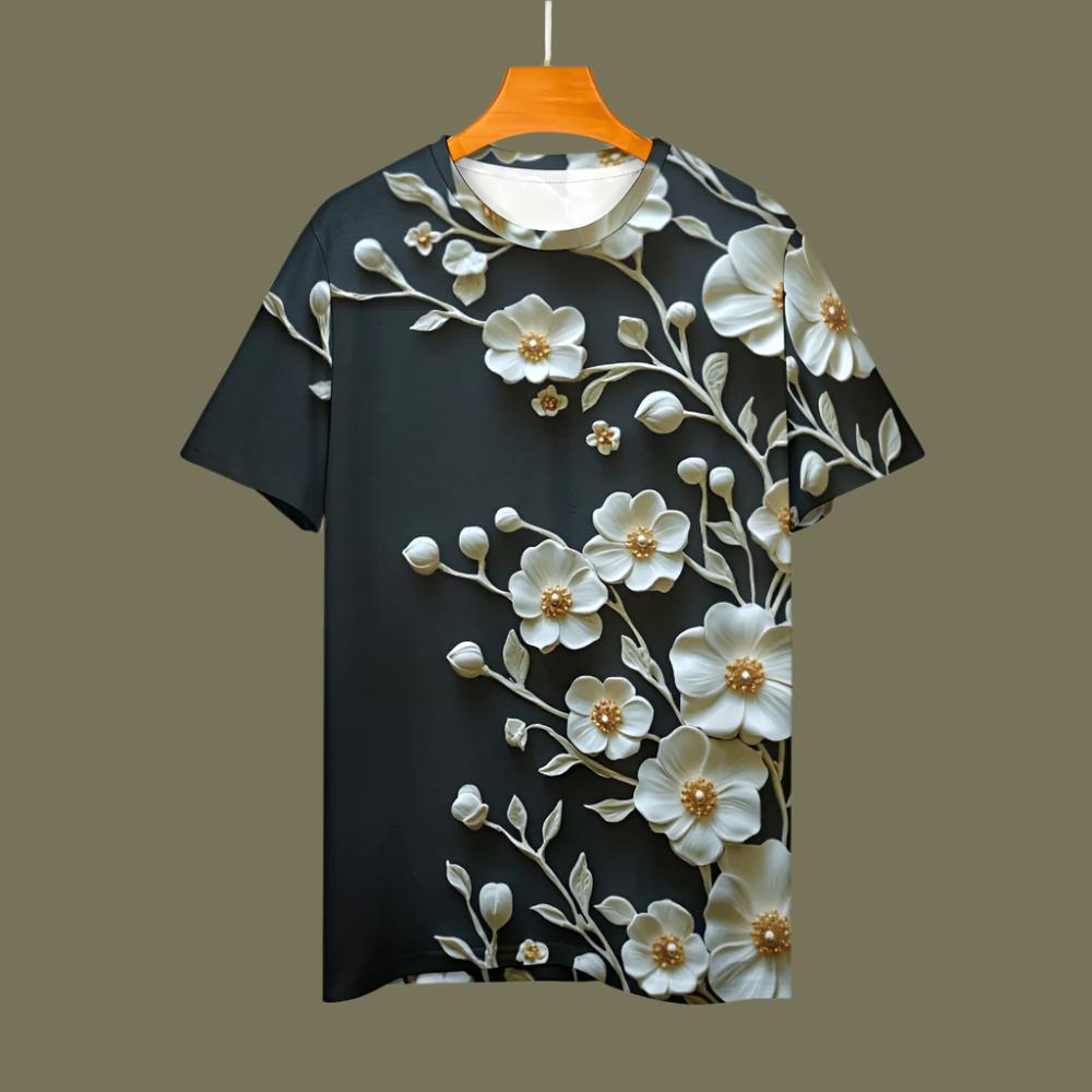 Whether paired with jeans for a casual look or tucked into a skirt for a more polished vibe, this floral tee is the perfect blend of comfort and chic design.

