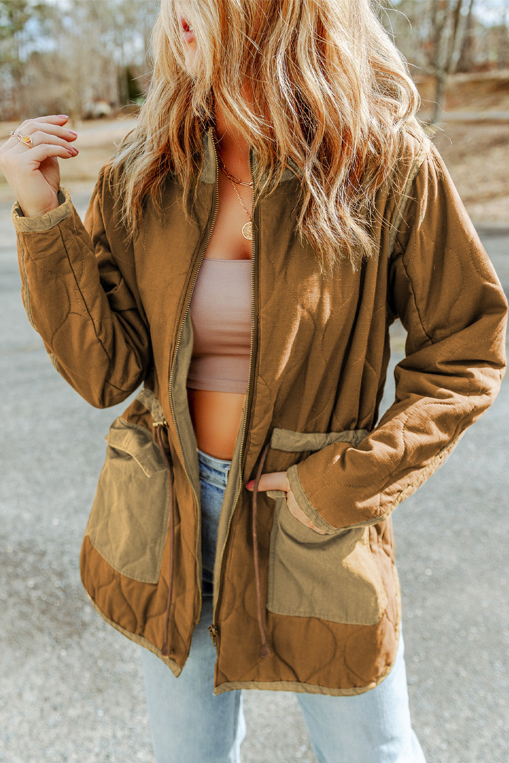 Stay warm and stylish with our Brown Stitching Quilted Drawstring Jacket. The high neck and drawstring provide excellent protection against the cold wind, while the zip-up design and pockets make it practical and easy to wear. Pair it with your favorite pants or jeans for a chic winter look.