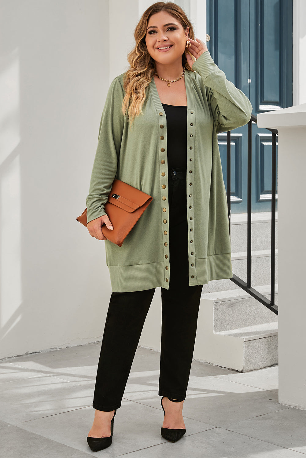 A versatile and dainty addition to any wardrobe, this green plus-size cardigan features a snap-button closure and ribbed trim for a vintage feel. With convenient pockets, it's perfect for adding a touch of warmth while running errands or lounging at home. Pair with a long-sleeve top and skinny pants for a complete casual look. (Fits ladies of all sizes!)