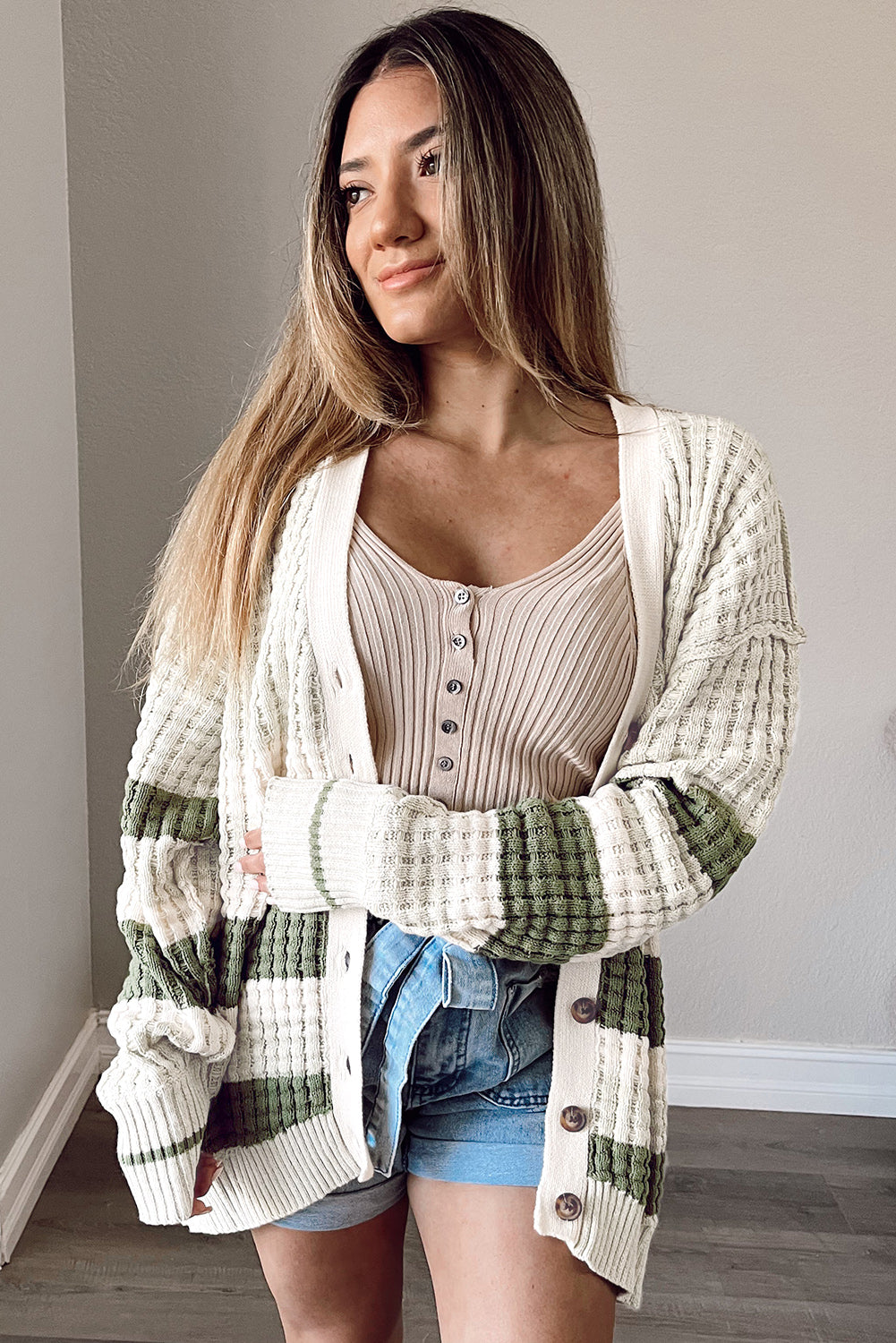 Get ready to add some color to your wardrobe with this Green Colorblock Textured Knit Buttoned Cardigan! The block-striped lightweight weave brings a playful touch to any outfit, while the rows of buttons down the front make for easy layering. Plus, the carefully knitted patterns and ribbed details add a touch of elegance to this quirky and fun cardigan.