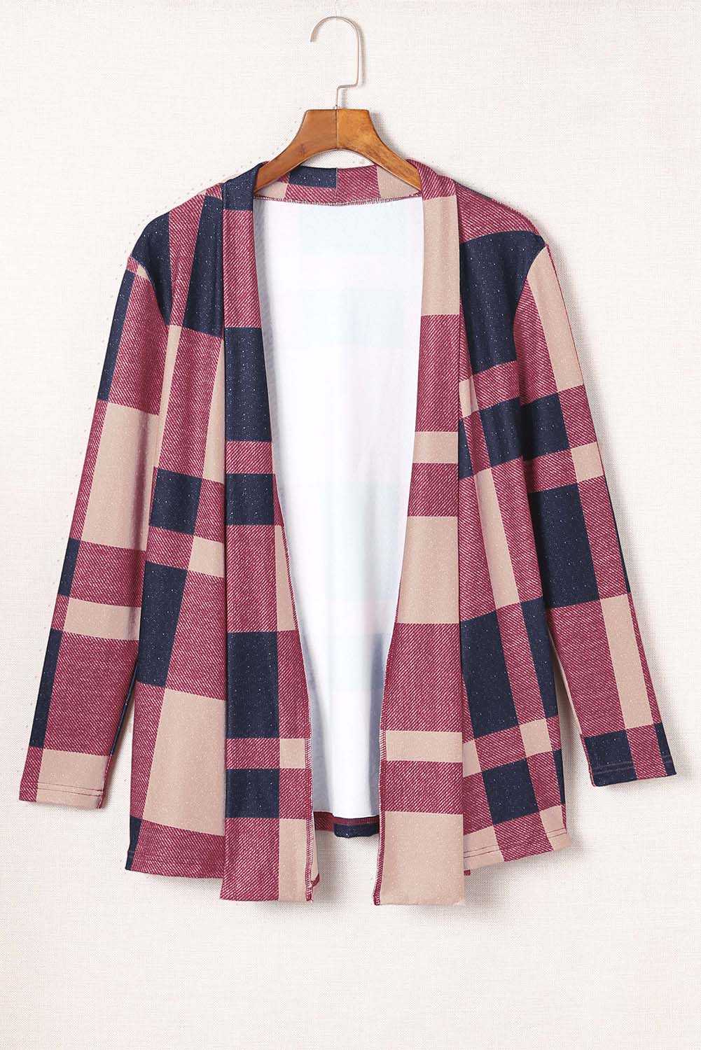 Unleash your inner fashionista with our Draped Open Front Plaid Cardigan. This versatile piece adds a touch of casual chic to any outfit. The draped design creates a relaxed look, while the open front allows for easy styling with a t-shirt, jeans, and sneakers. Made with soft and lightweight fabric for a cozy feel. Unleash your style and comfort with this must-have cardigan.