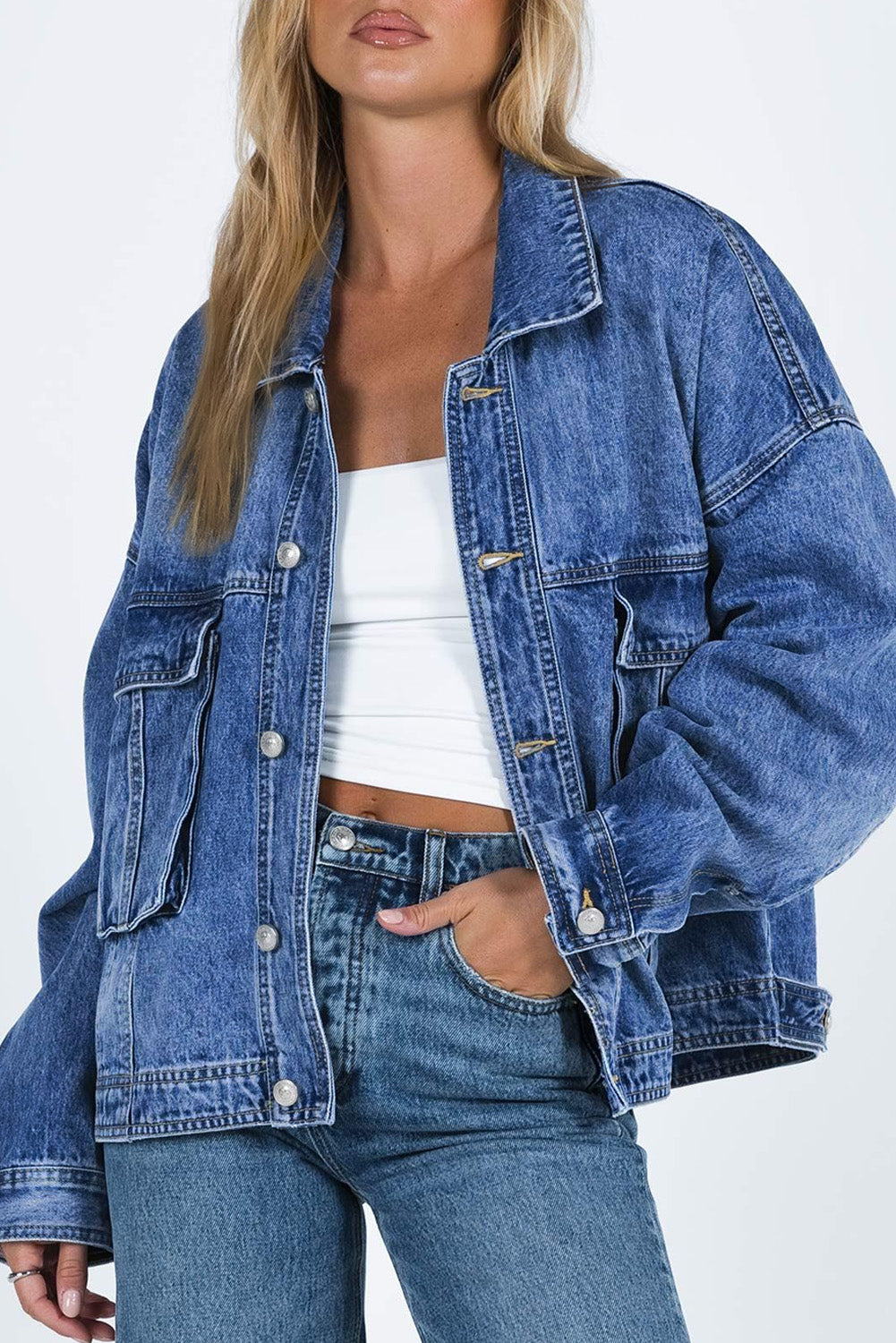 Get ready to drop it like it's hot in our Blue Chest Pockets Drop Shoulder Loose Denim Jacket! With its trendy oversized fit, convenient chest pockets, and unique dropped shoulder design, this jacket is perfect for a casual, yet stylish look. Say hello to your new favorite wardrobe staple, available now in blue denim.