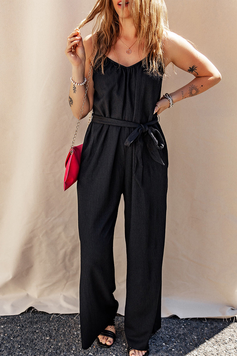 Elevate your style with our Black Textured Belted Wide Leg Sleeveless Jumpsuit. This elegant piece is designed to offer comfort and versatility, with its wide leg design and sleeveless top. The textured fabric and belted waist add a touch of sophistication, making it perfect for any occasion. Step out in style and turn heads wherever you go!