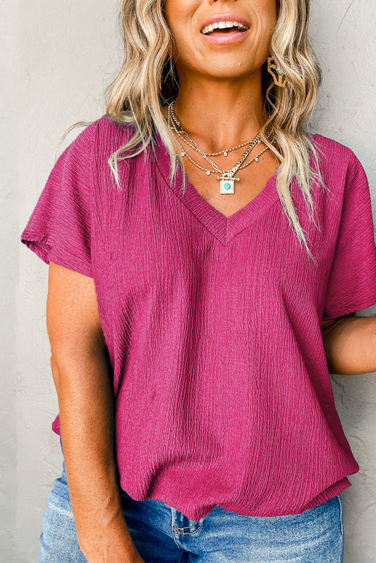 Elevate your wardrobe with our Bright Pink Textured V Neck Bubble Hem Plus Top. The unique texture adds a stylish touch, while the relaxed fit and bubble hem create a comfortable and flattering silhouette. Made with fine fabric, this top is not only chic, but incredibly comfortable. Easily style it with any outfit for a confident and fashionable look.