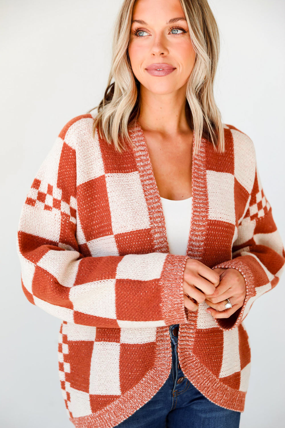 Introducing our Chestnut Mix Checkered Cardigan, a chic and classic addition to any wardrobe. Its checkered pattern is sure to make you fall in love with this knit coat. The open front design makes it easy to layer over any outfit, perfect for pairing with jeans, skirts, or dresses.