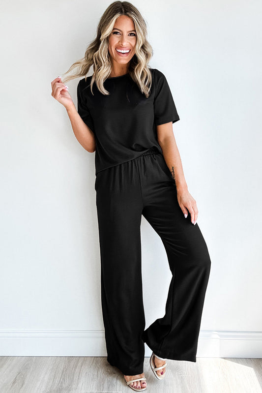 This stylish and versatile Black 2pcs Set includes a T-shirt with short sleeves and a round neck, paired with wide leg pants. Perfect for any occasion, this set not only offers comfort but also makes a statement with its solid color design. Elevate your wardrobe with this must-have piece!
