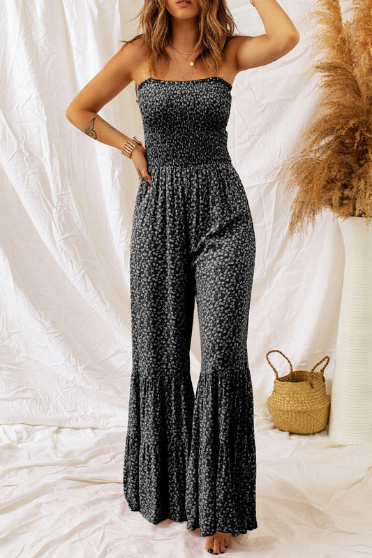 Elevate your style with our Black Thin Straps Smocked Bodice Wide Leg Floral Jumpsuit! The smocked bodice provides a flattering fit, while the wide leg design adds a touch of drama to your look. With delicate thin straps and a beautiful floral print, this jumpsuit will turn heads and make you feel confident and stylish. Perfect for any occasion!