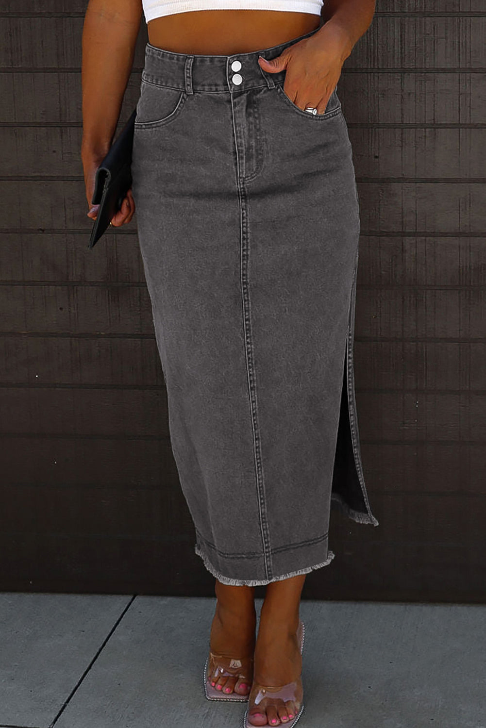 Introducing our stunning Black Raw Edge Side Slits Button Up Midi Denim Skirt! Crafted with high-quality denim, this skirt is perfect for any occasion. The raw edge and side slits add a touch of edginess, while the button-up design adds a dash of sophistication. Elevate your wardrobe with this must-have piece!