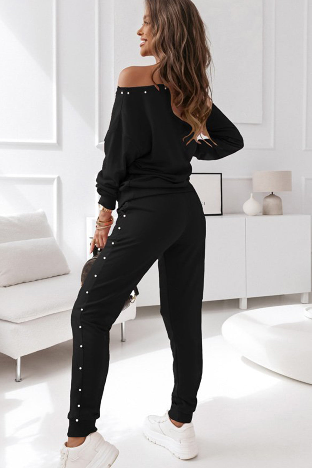 Elevate your loungewear game with our Black Beaded Decor Pullover and Jogger Pants Set. The intricate beaded design adds a touch of glam while the soft and comfortable fabric ensures maximum coziness. Stay stylish and comfortable in this must-have set.