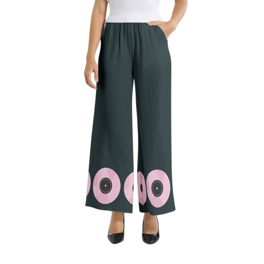 Experience the perfect harmony of style and comfort with our Designer Graphic Print Pants and Matching Crop Top. The black pants feature a vibrant pink record design at the hem, while the pink crop top boasts black musical notes flowing across the sleeves and chest. Elevate your fashion game and make a bold statement with this eye-catching set!