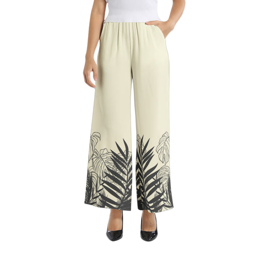Experience effortless style with our Women's Beige Designer Pant and Matching Top. The graphic print of black tropical leaves adds a touch of elegance to the wide leg silhouette. The elastic waistband ensures a comfortable and flattering fit, perfect for any occasion. Upgrade your wardrobe with this must-have set.